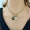 gold paperclip chain with cz carabiner and 4 black and gold charms